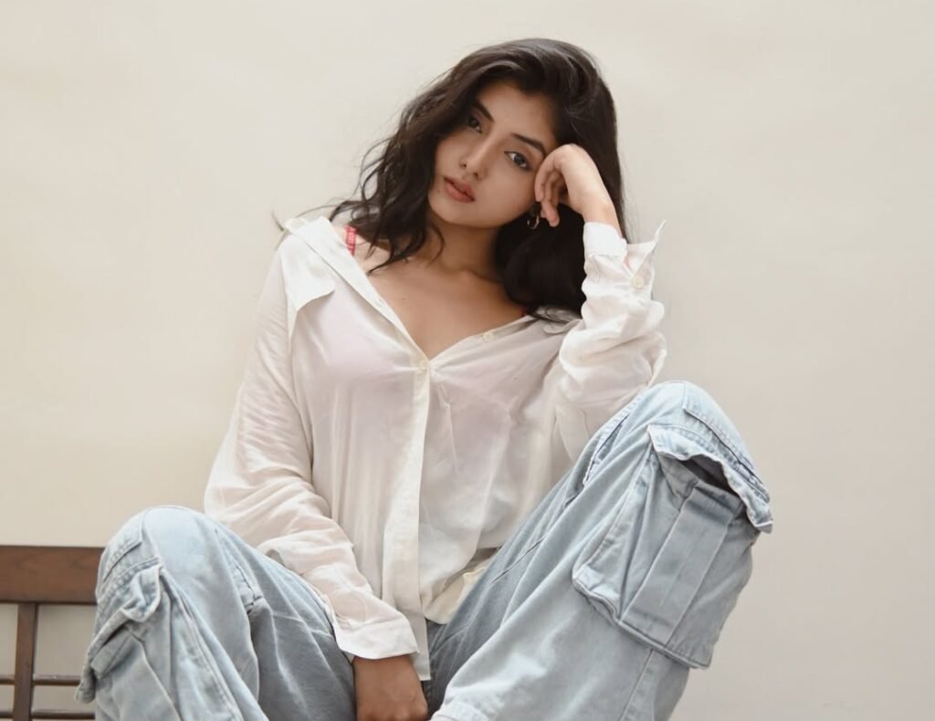Khushi Mali setting on a chair with white shirt