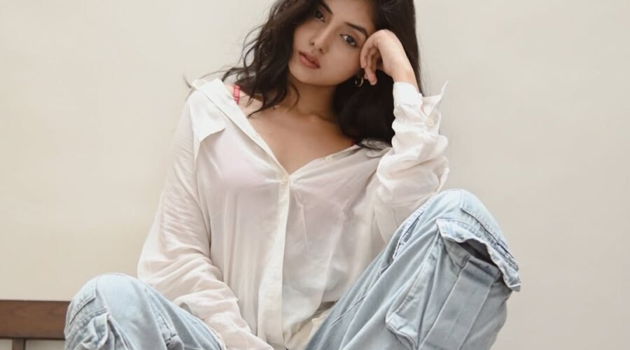 Khushi Mali setting on a chair with white shirt